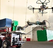 Moving robot with coloured ‘building blocks’ and drone. (Photo: Mikal Schlosser)